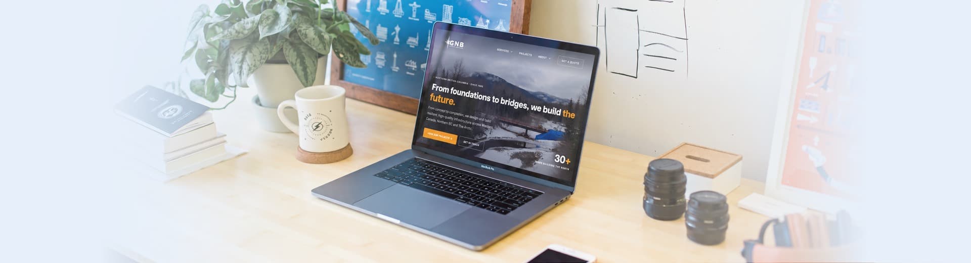 A laptop on a bright desk showing a client website